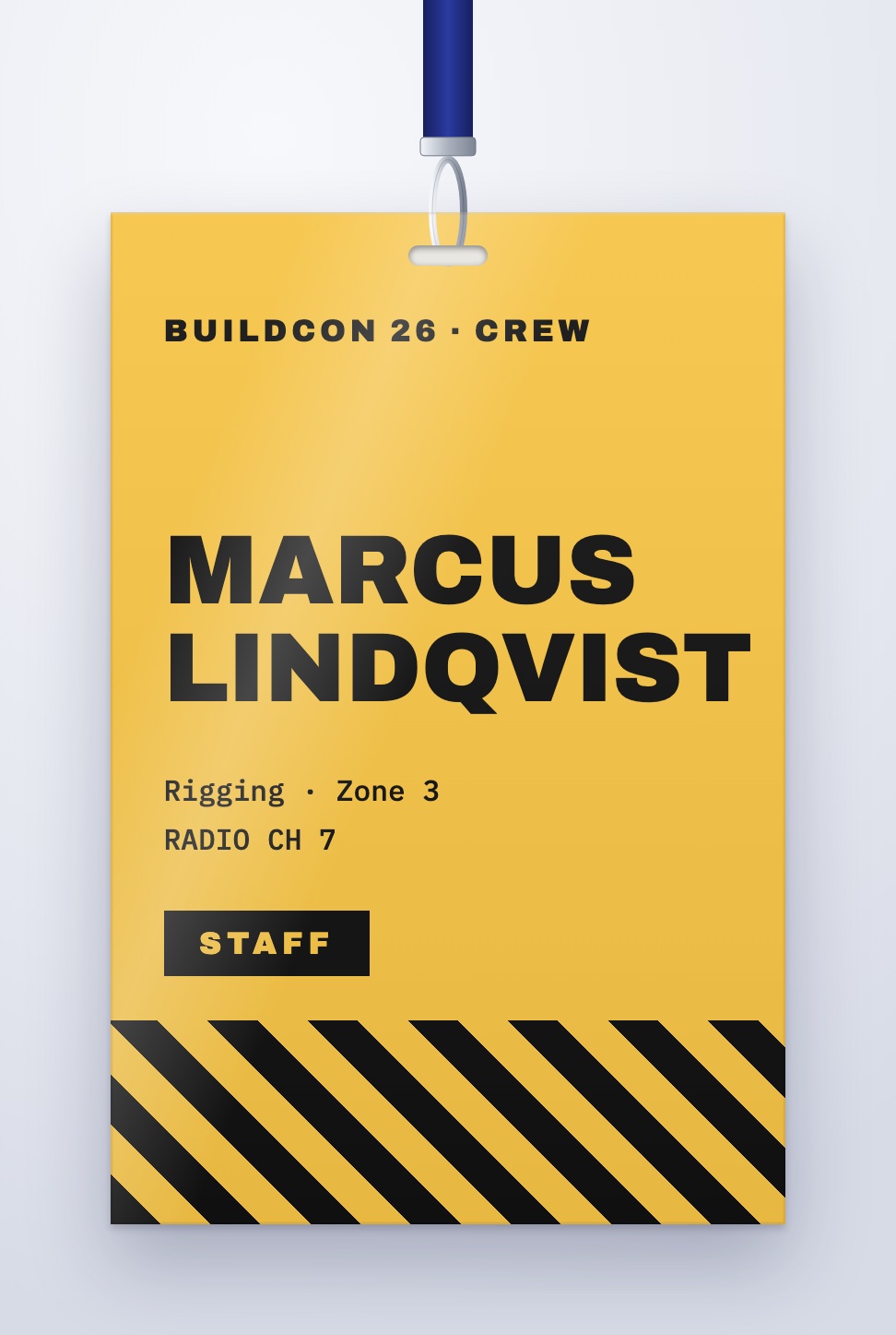Patterned crew badge design in yellow with black hazard stripes and a STAFF label, on a lanyard
